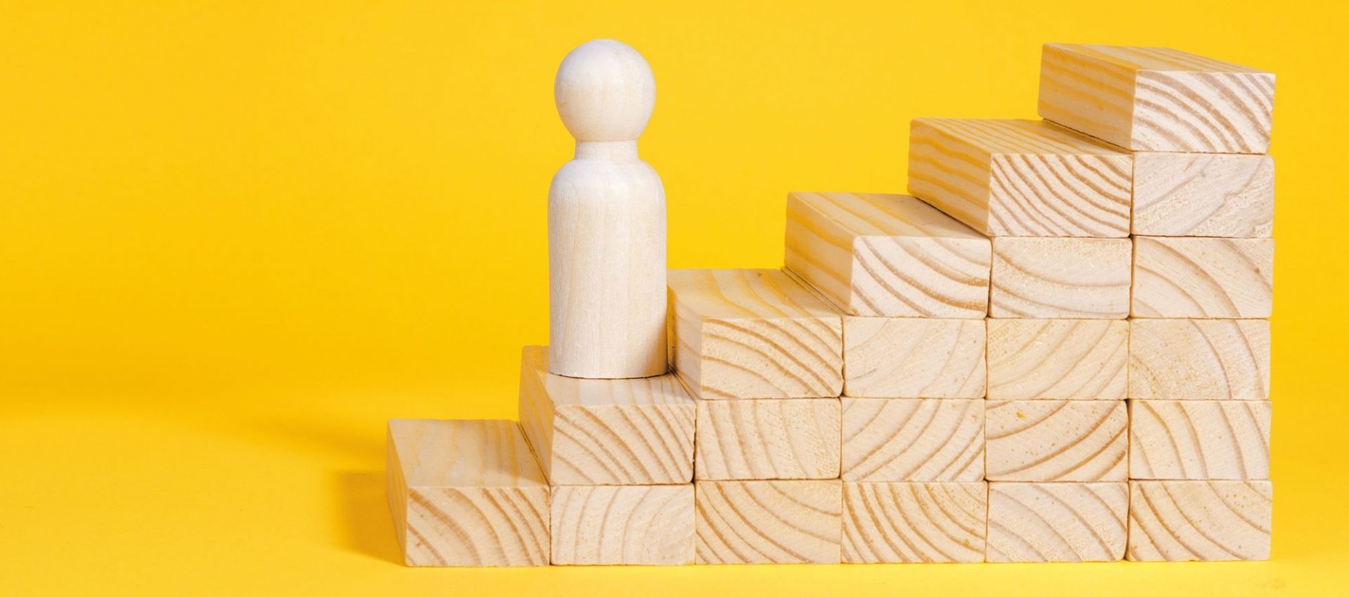 Businessman climbing stairs. Business success process, career ladder. Wooden figurine